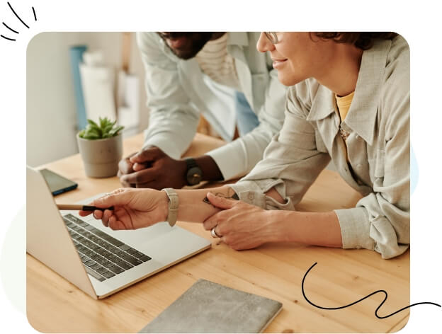 Two people looking at security performance on a laptop